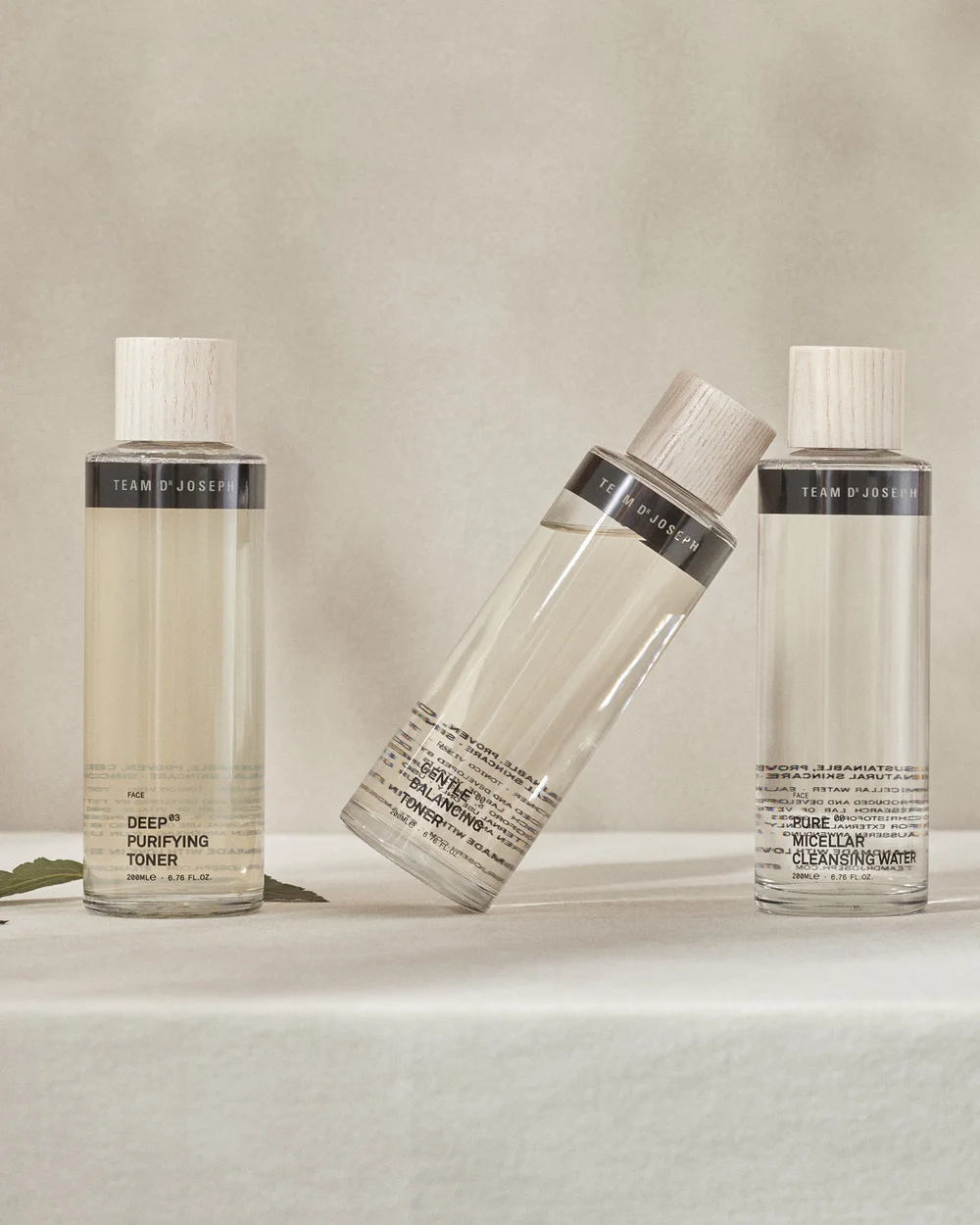 Relaxing moments at our spa hotel in Switzerland Three clarifying face toners in bottles with wooden caps on beige background