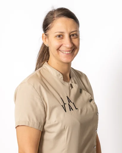 Portrait of a smiling woman in beige work uniform against white background
